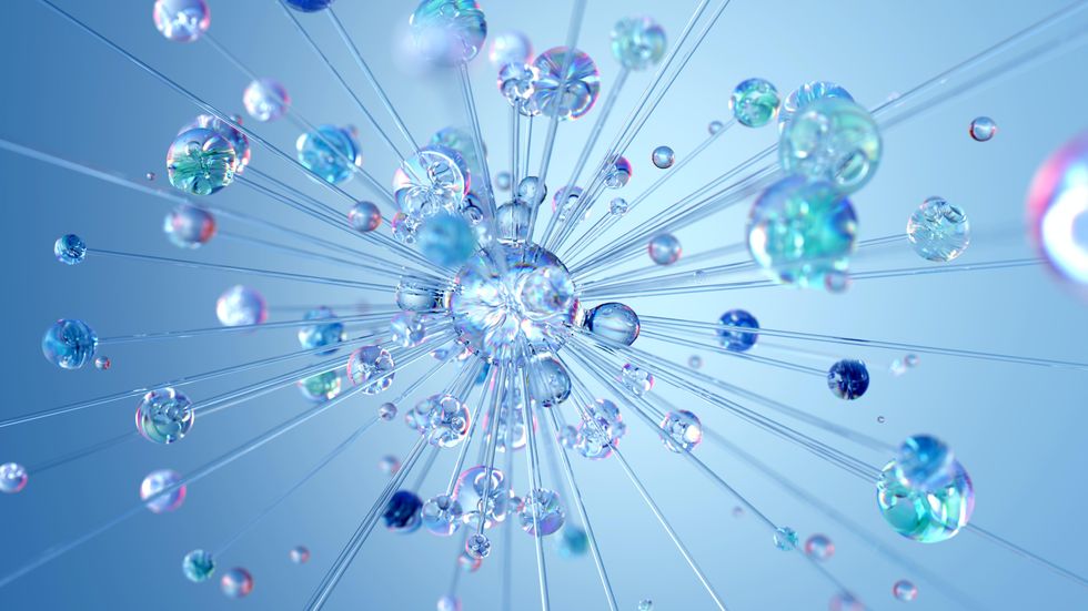 Detailed image of a close up of water drops falling from a shower-head