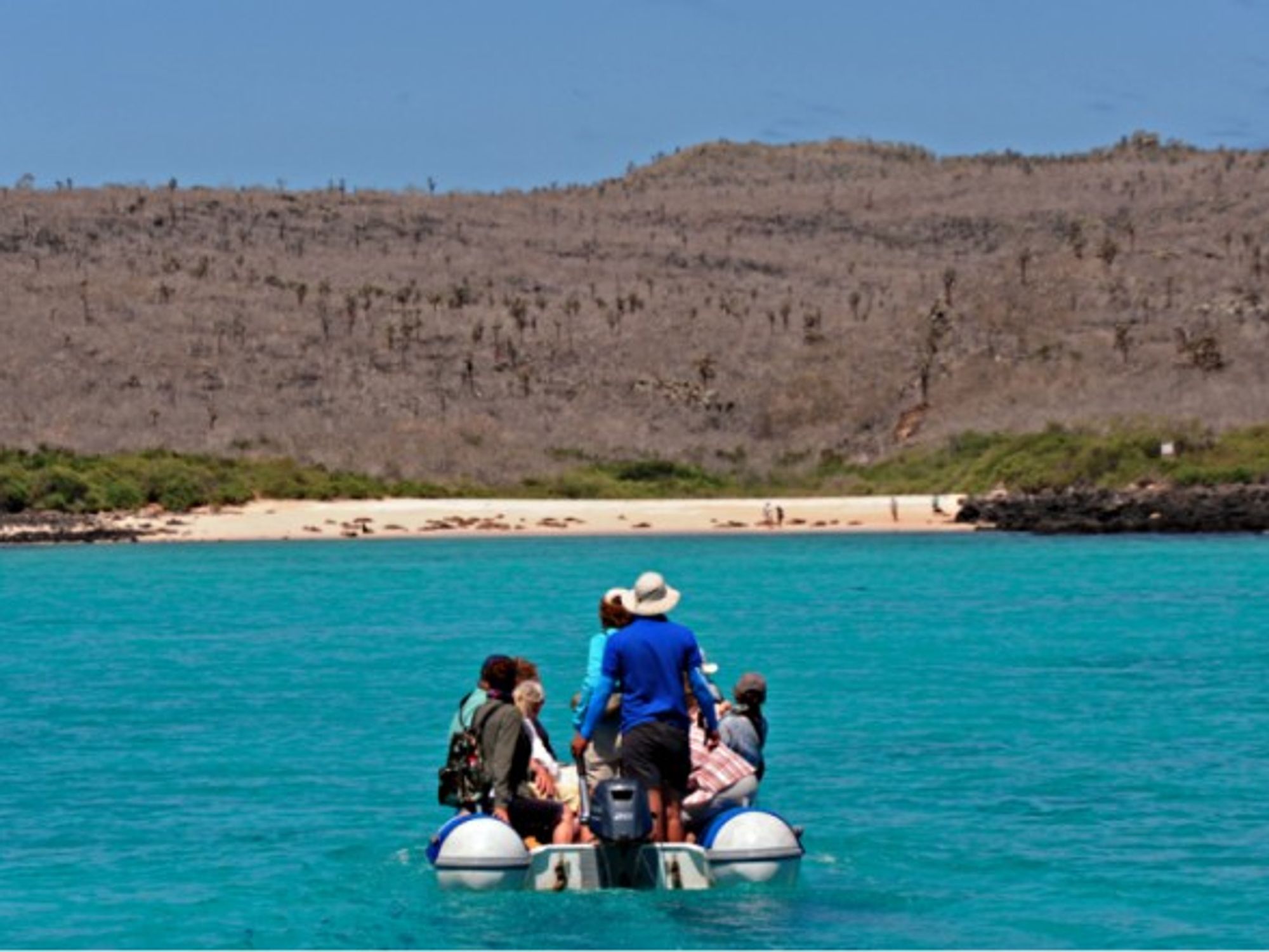Dinghy headed to a Galapagos island