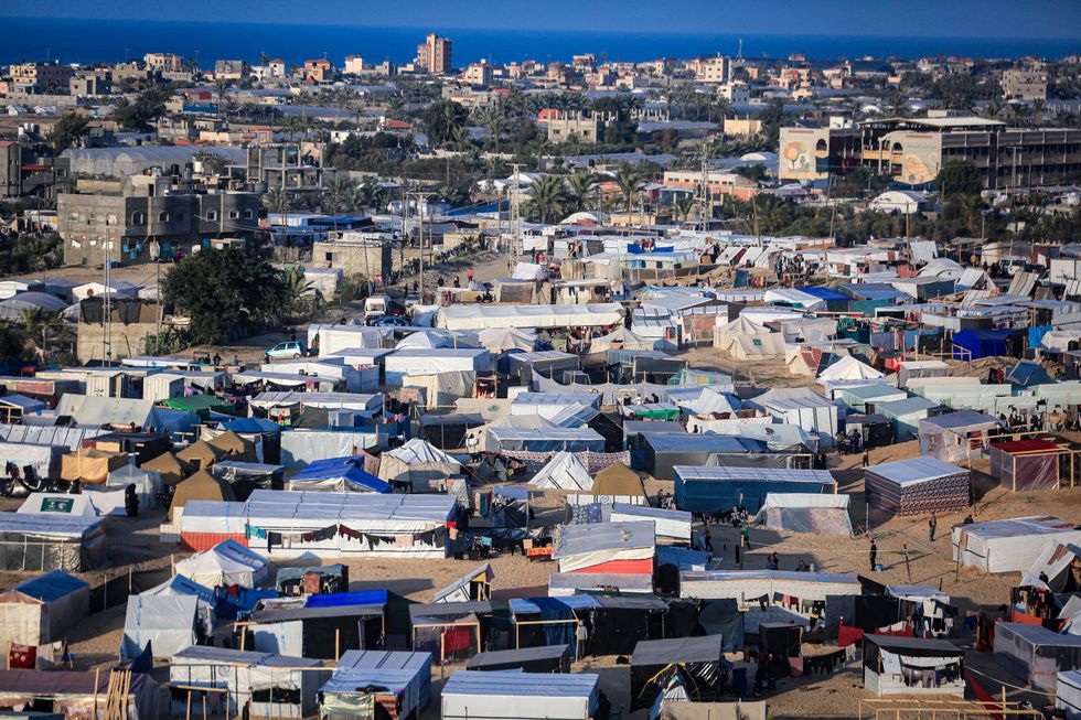 Displaced Palestinians in Rafah, who fled their homes due to Israeli raids, take shelter in a camp, amid the ongoing conflict.