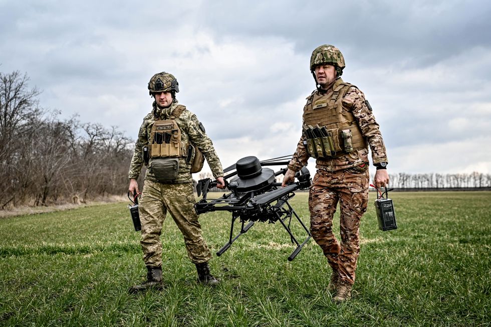Dnipro unmanned combat aerial complex platoon of the 108th Separate Territorial Defence Brigade carry a Vampire drone, a Ukrainian unmanned combat aerial vehicle (UCAV) which has a payload of up to 15kg (33lbs).