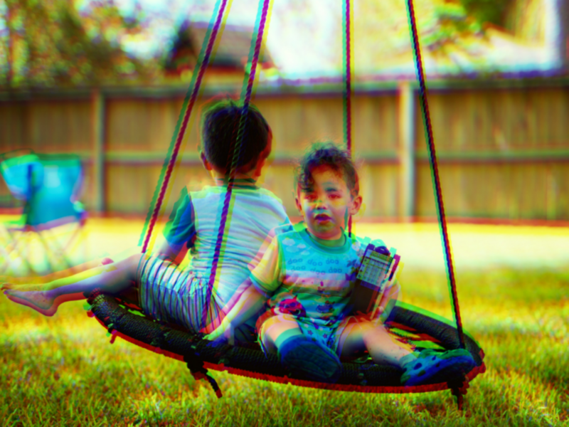 Doctored photo of children playing on a swing