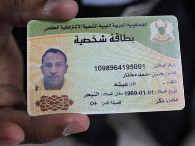 Doctors in Brega, Libya show identity card of a slain pro-Gaddafi fighter they say was a Tuareg from Niger
