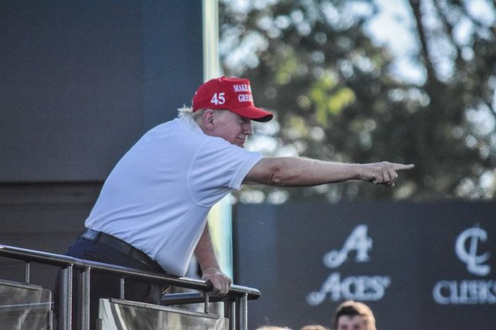Donald J. Trump points his finger in the air to supporters.