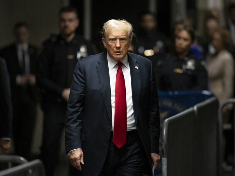 Donald Trump amongst barricades and police officers.