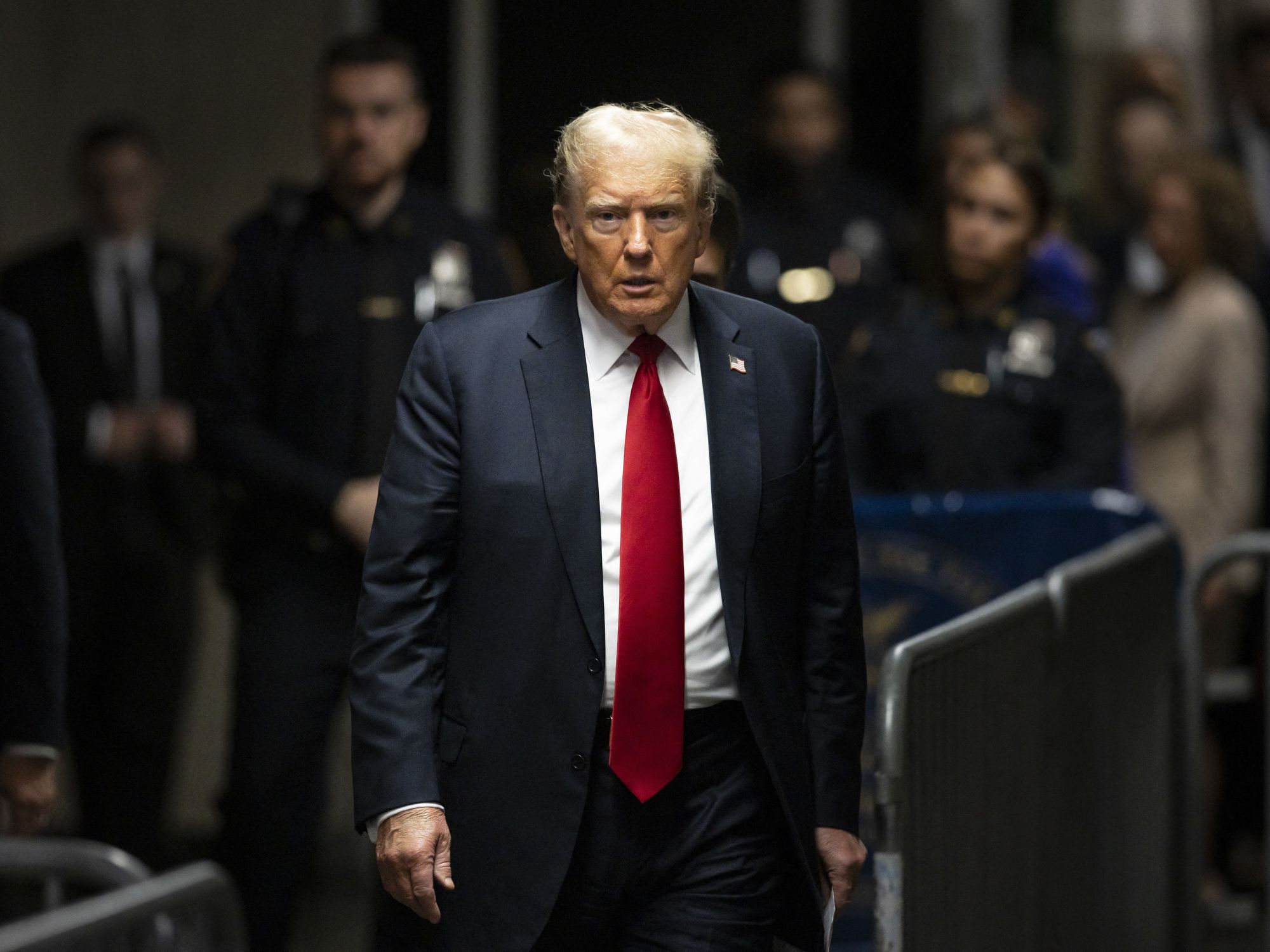 Donald Trump amongst barricades and police officers.