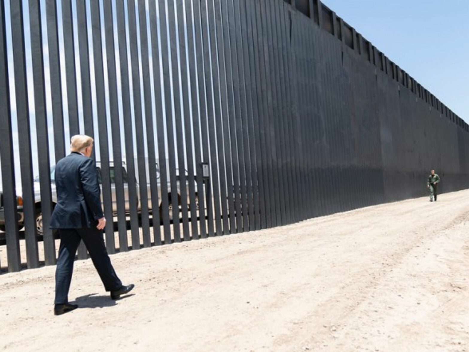 Donald Trump walking along the Mexican-American border