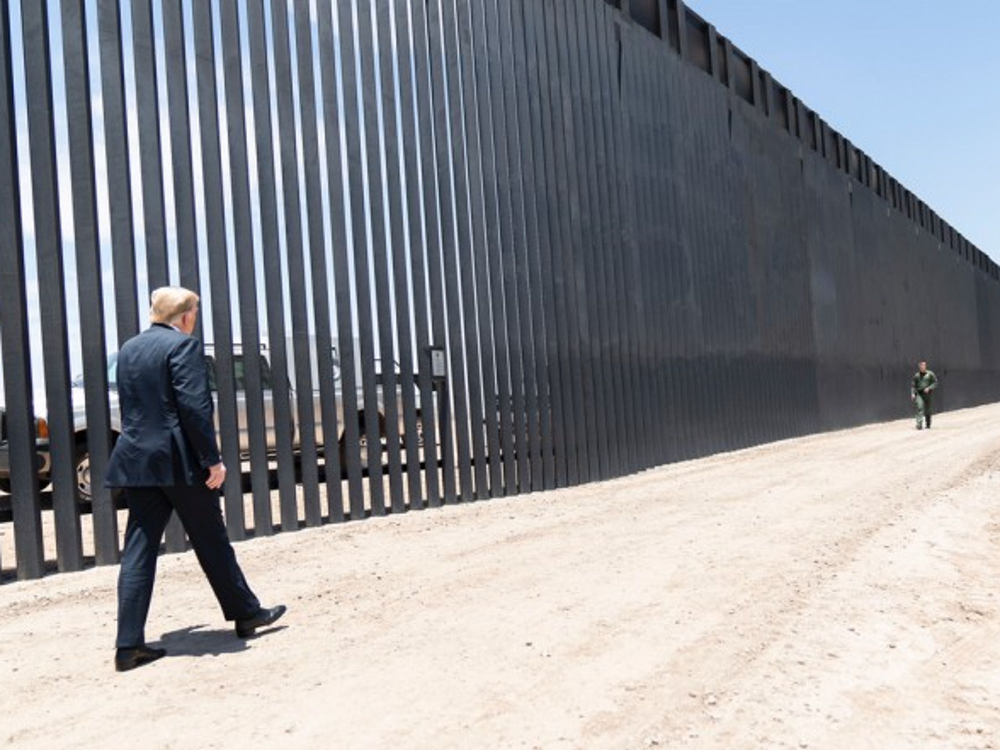 Donald Trump walking along the Mexican-American border