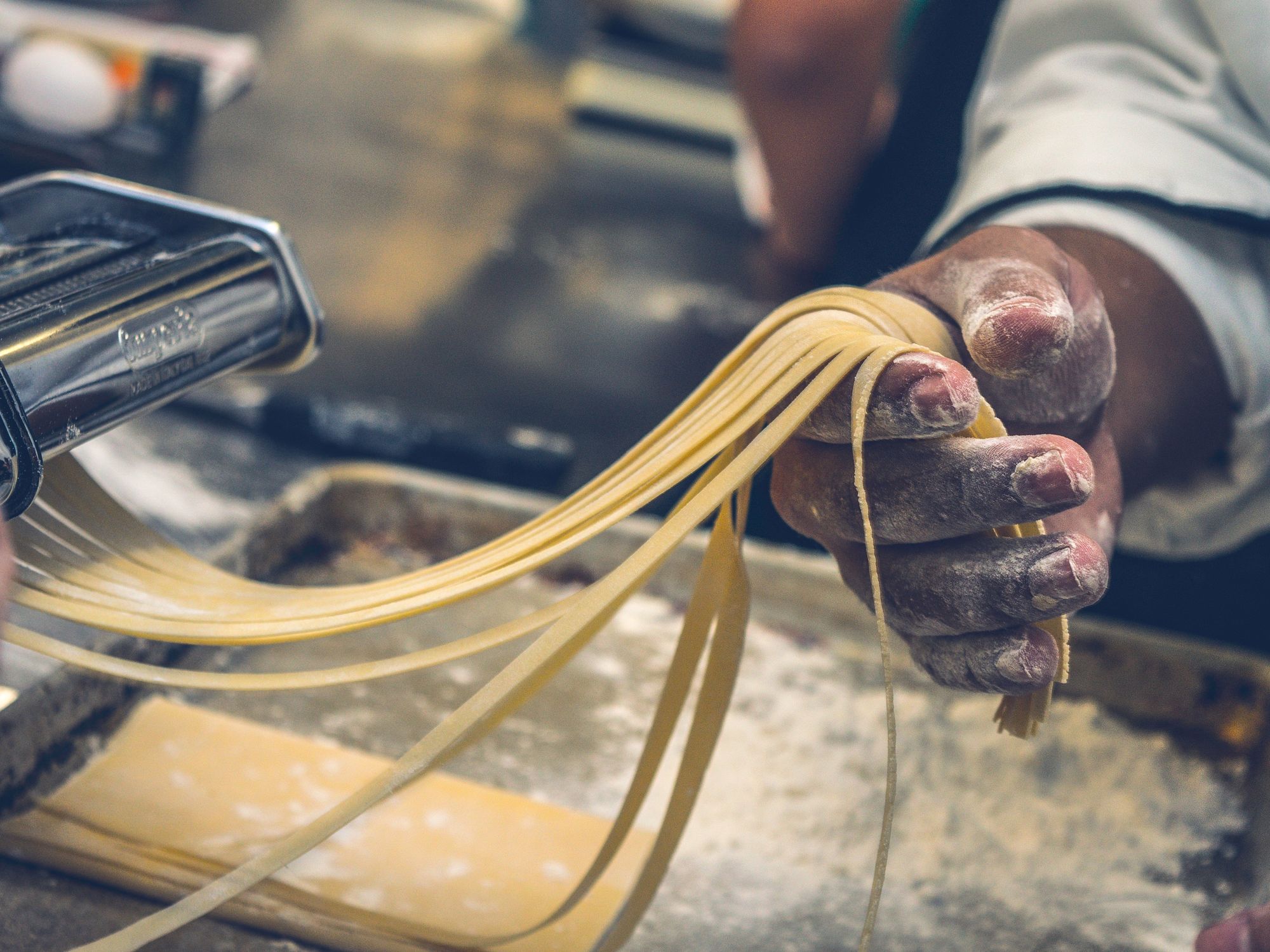 Dough is run through a press to make pasta