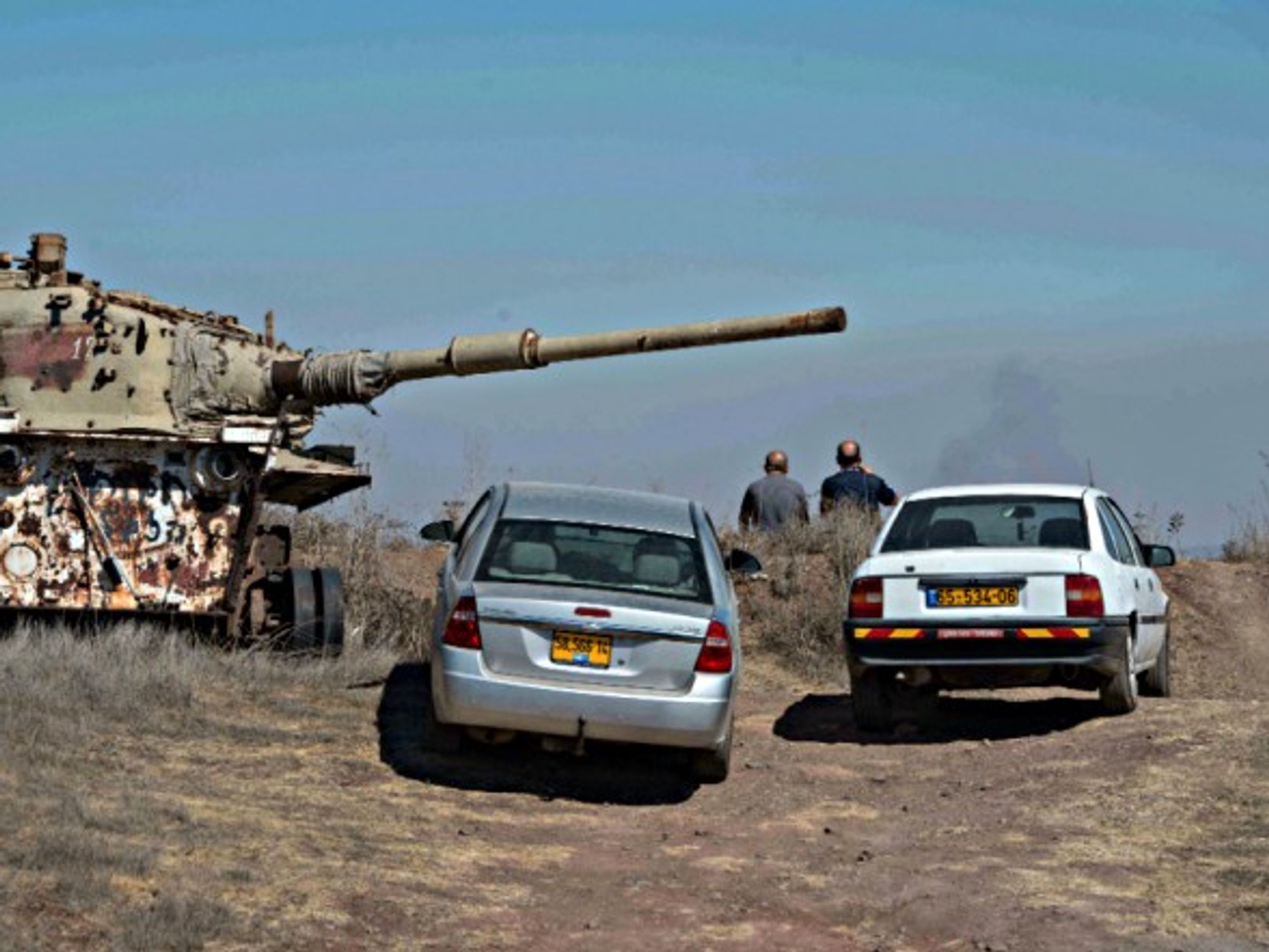 Druze residents watch fighting on the Syrian side of the border from vantage point in Golan Heights
