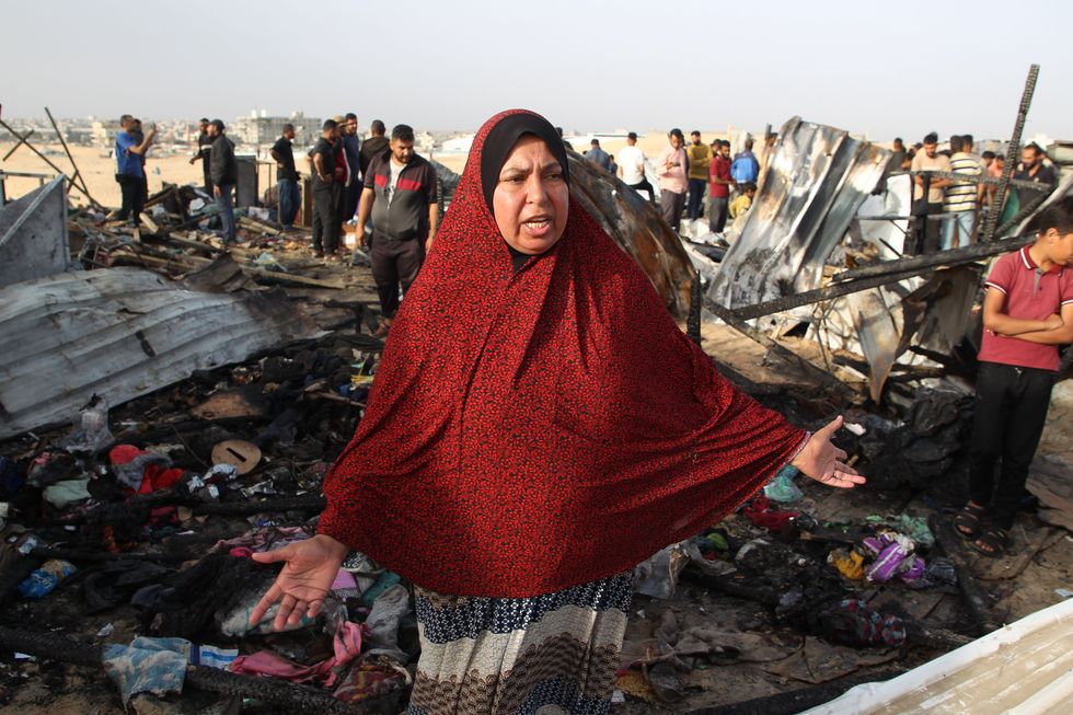 ​ A dismayed woman reacts at the site of an Israeli strike on a camp for displaced people in Rafah in the southern Gaza Strip.