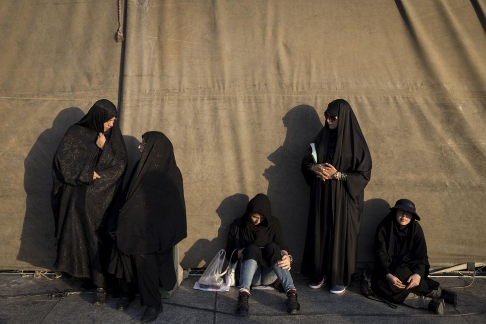 ​ Iranian women take part in a ceremony under the sun