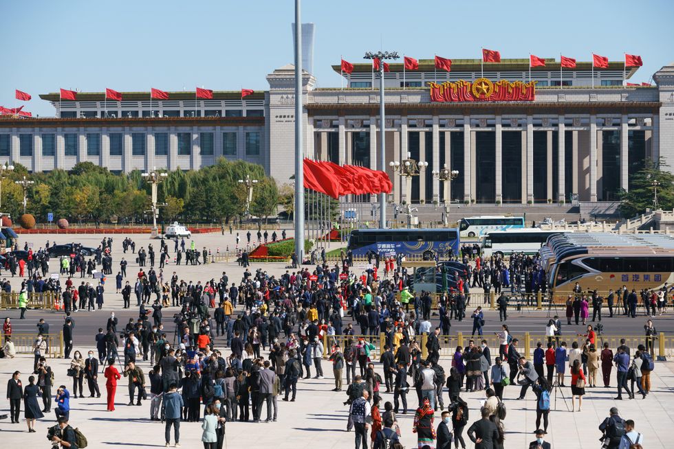 ​A crowd gathers outside of the Great Hall of the People, in Tiananmen Square, during the closing ceremony of the 20th National Congress of the Communist Party of China (CPC), October 2022.