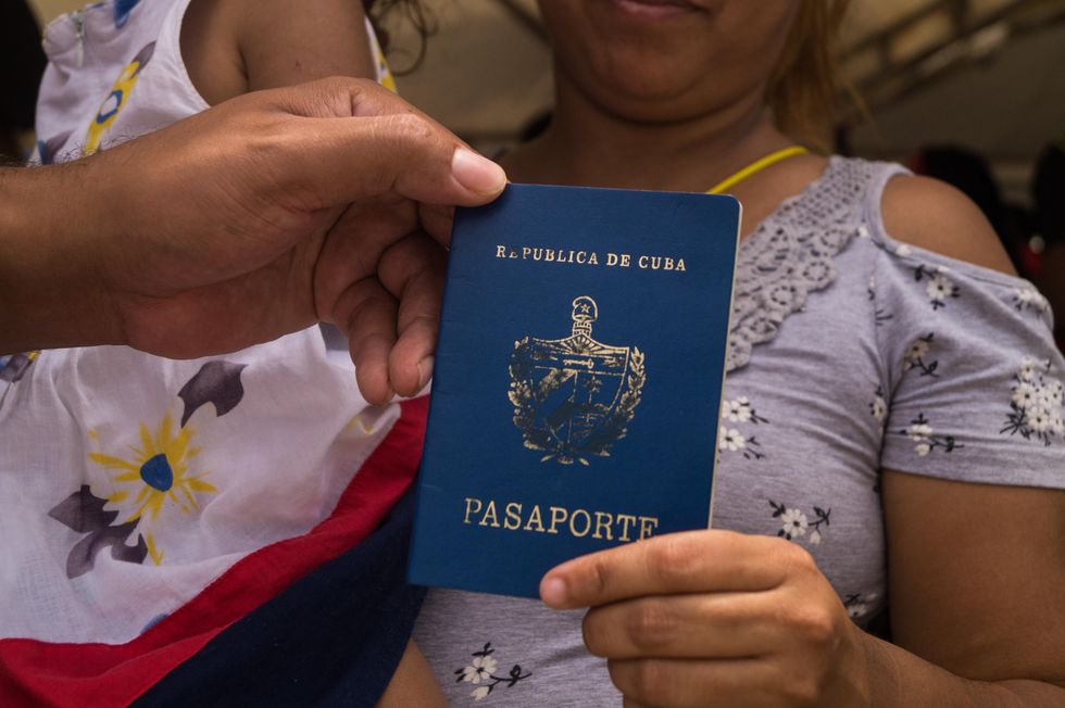 ​A Cuban migrant shows her Cuban passport