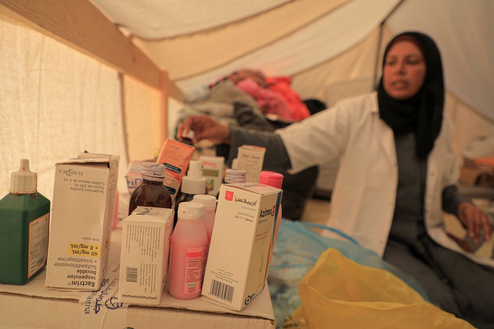 ​A doctor picks medicines for a patient at a temporary clinic in the southern Gaza Strip city of Rafah.