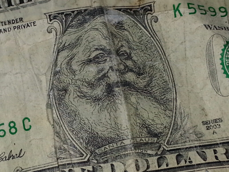 ​A fake dollar bill with Santa Claus' face.