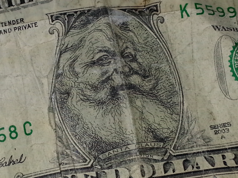 ​A fake dollar bill with Santa Claus' face.