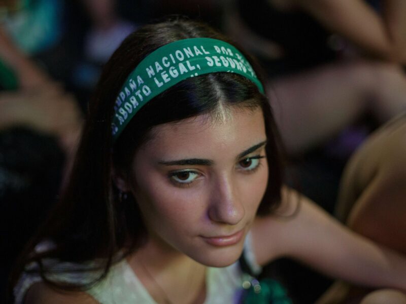 ​A girl wears the green scarf of the National Campaing for the Right to Abortion as a headband in a pro-choice demonstration outside the National Congress building, Buenos Aires, December 10, 2020.