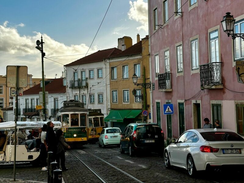 ​A group of cars parked on a side road in Lisbon, Portugal.
