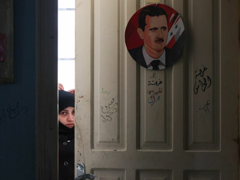 ​A local woman is seen in a temporary accommodation facility set up in a former school building.