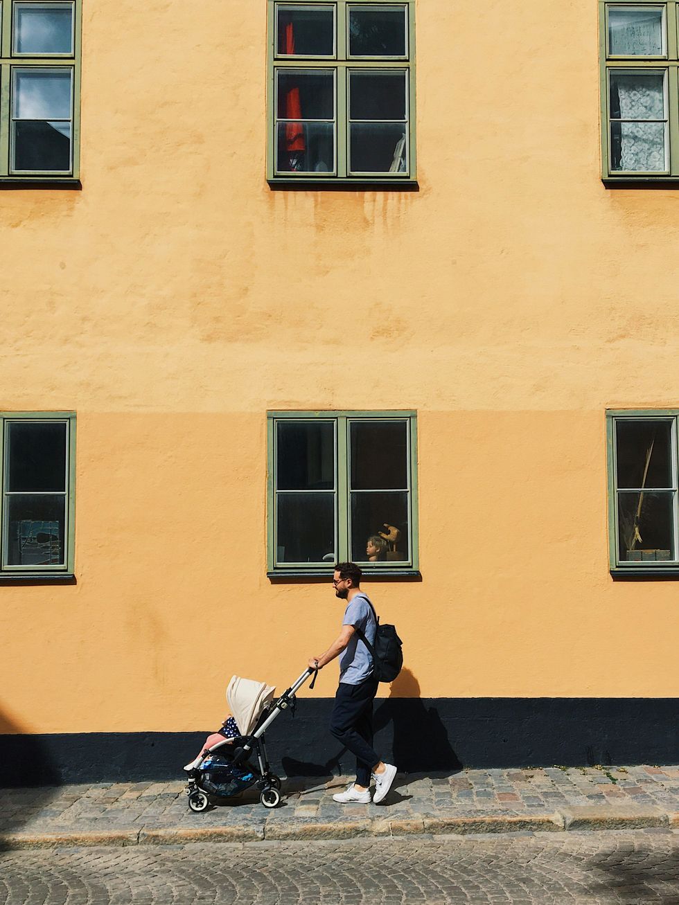 ​A man pushes a baby stroller in Södermalm, Stockholm, Sweden, June 30, 2020.