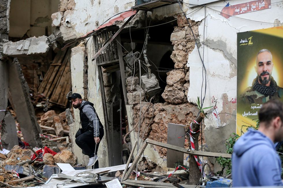 ​A man stands next to the site where an Israeli air drone hit the building in the area of Zkak al-Blat in the heart of Beirut, killing 5 people, Beirut, Lebanon, Nov. 19, 2024.