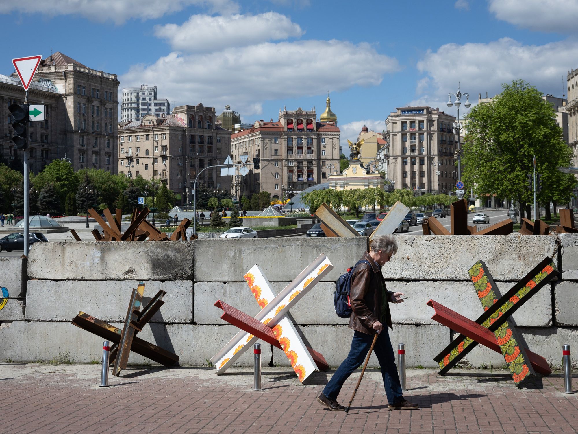 ​A man walks near anti-tank hedgehogs in central Kyiv.