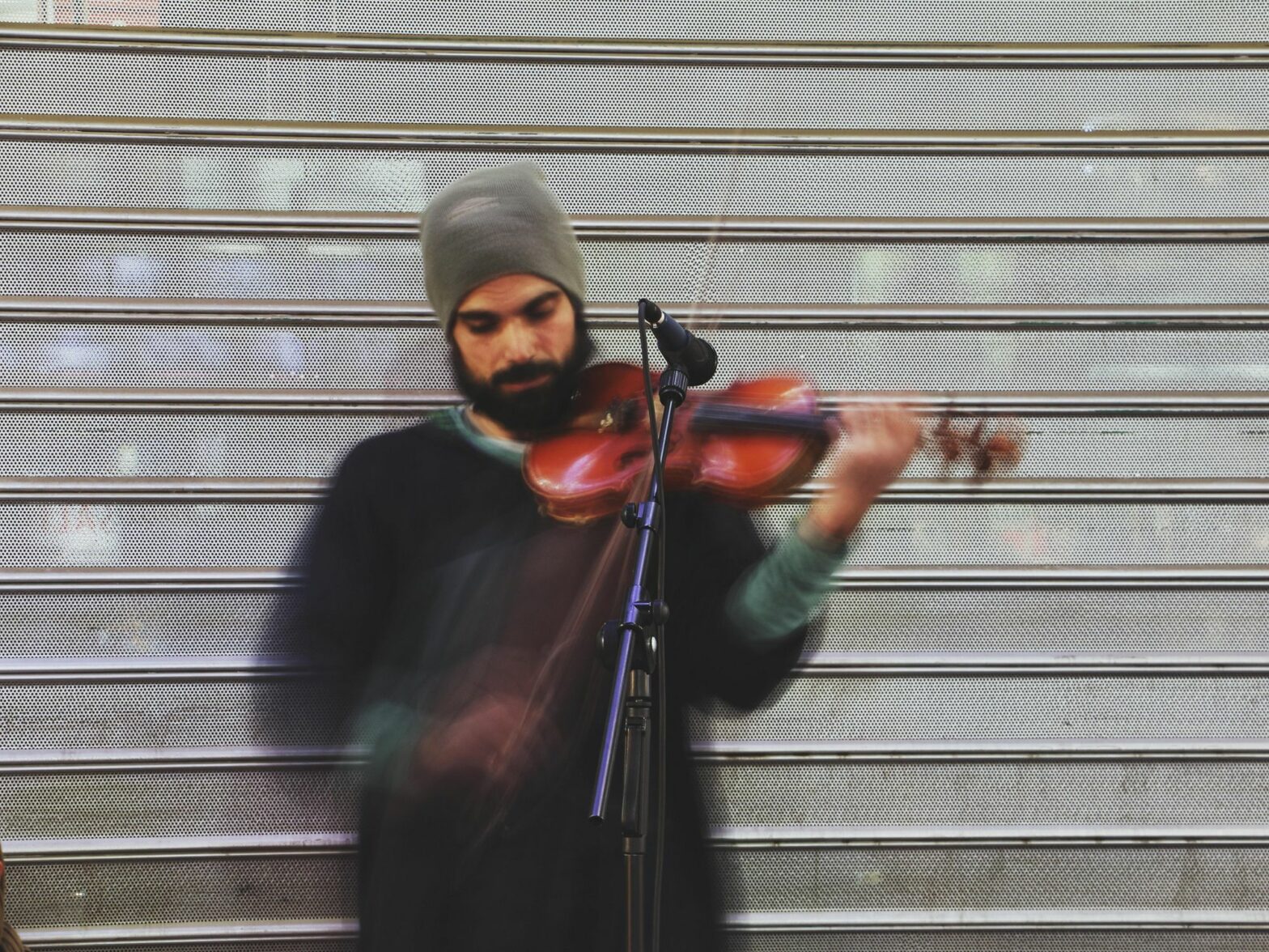 ​A man with a beanie playing the violon in Tehran, Iran
