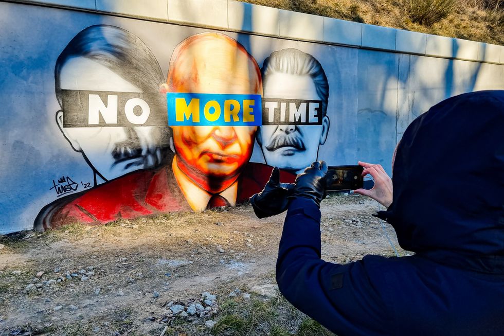 ​A mural of Putin, Hitler, and Stalin with the slogan ''No More Time'' is seen on the wall next to the PKM Gdansk Jasien train station.