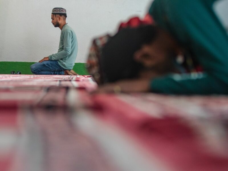 ​A Nepali Muslim man attends the mass prayers during the Eid al-Adha celebrations at the Kashmiri Takiya Jame mosque.