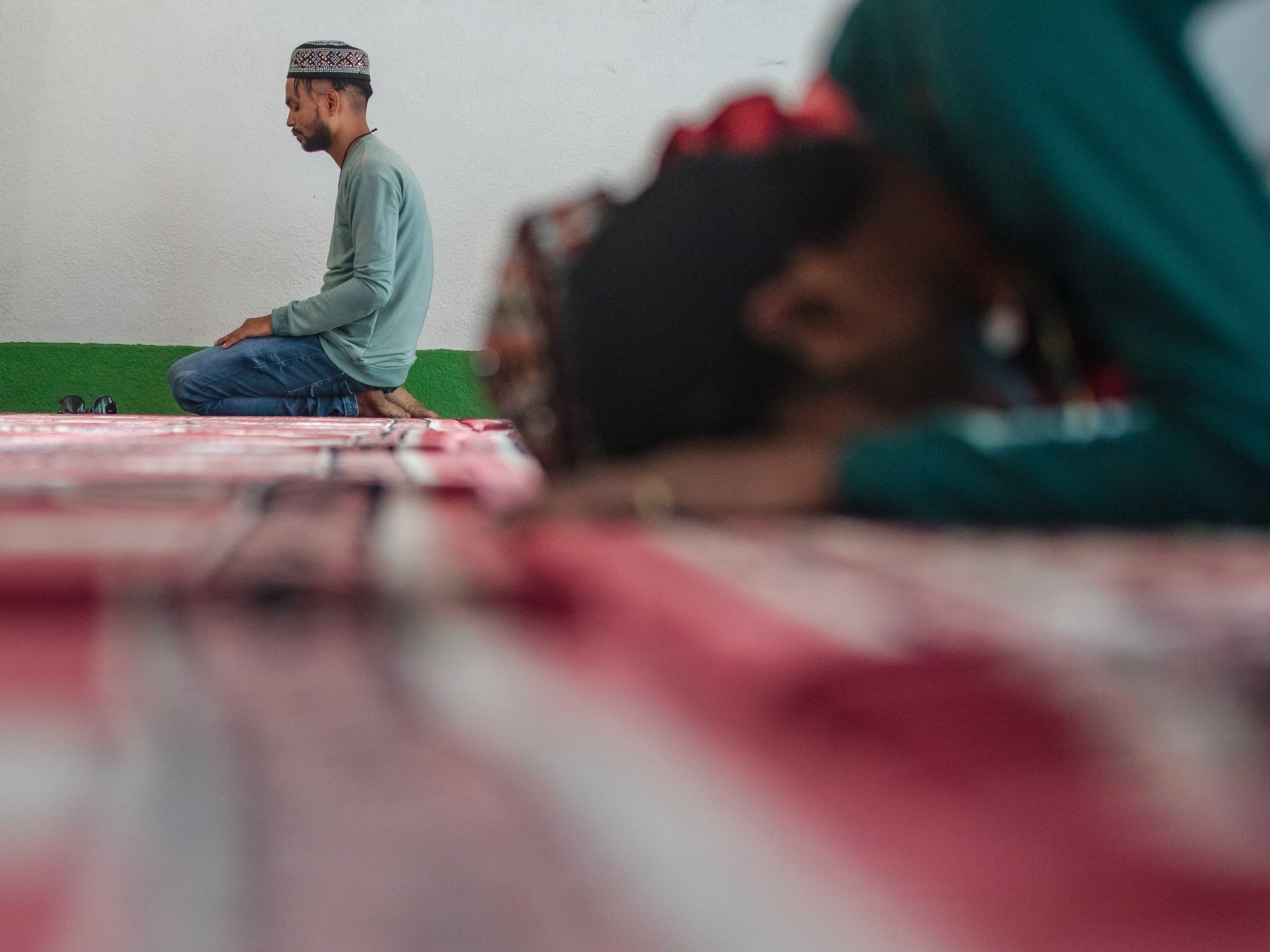 ​A Nepali Muslim man attends the mass prayers during the Eid al-Adha celebrations at the Kashmiri Takiya Jame mosque.