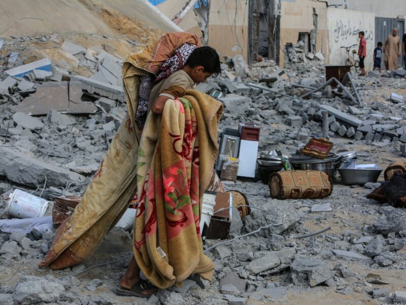 ​A Palestinian inspects a damaged house after Israeli warplanes bombed a home for the Al-Shaer family, leading to widespread destruction in the Al-Salam neighborhood.