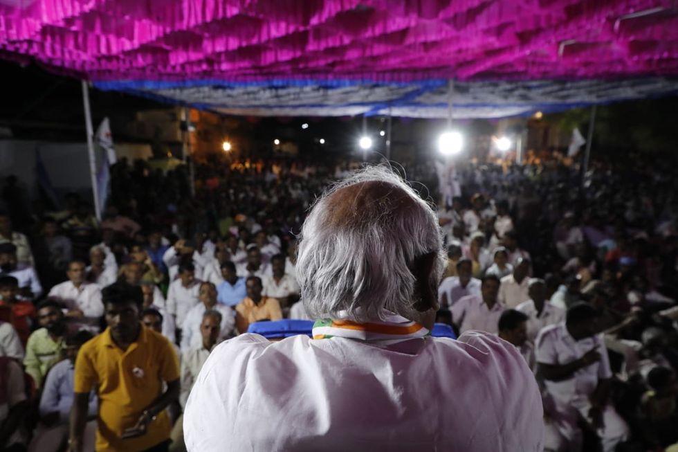 ​A photograph of Mallikarjun Kharge facing a crowd.