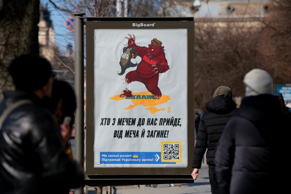 ​A poster with the phrase 'He Who Comes with the Sword Will Die by the Sword' pictured in Lviv
