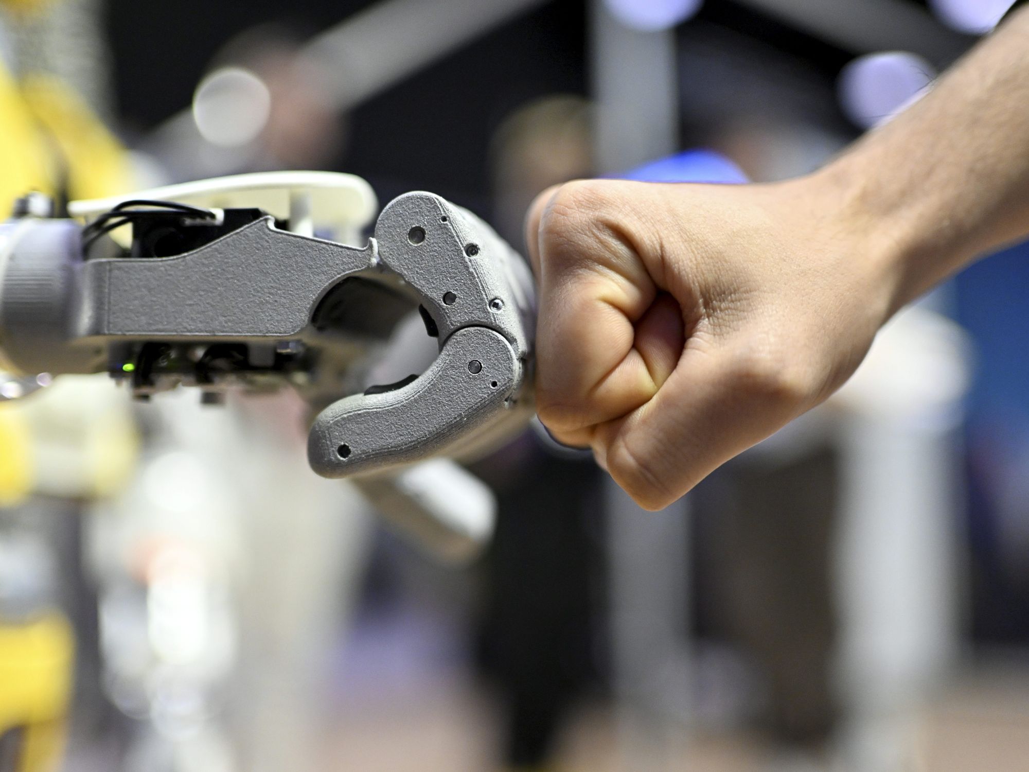 ​A robot and human fistbump at the 2024 IEEE-RAS International Conference on Humanoid Robots in Nancy, France, Nov. 23, 2024.