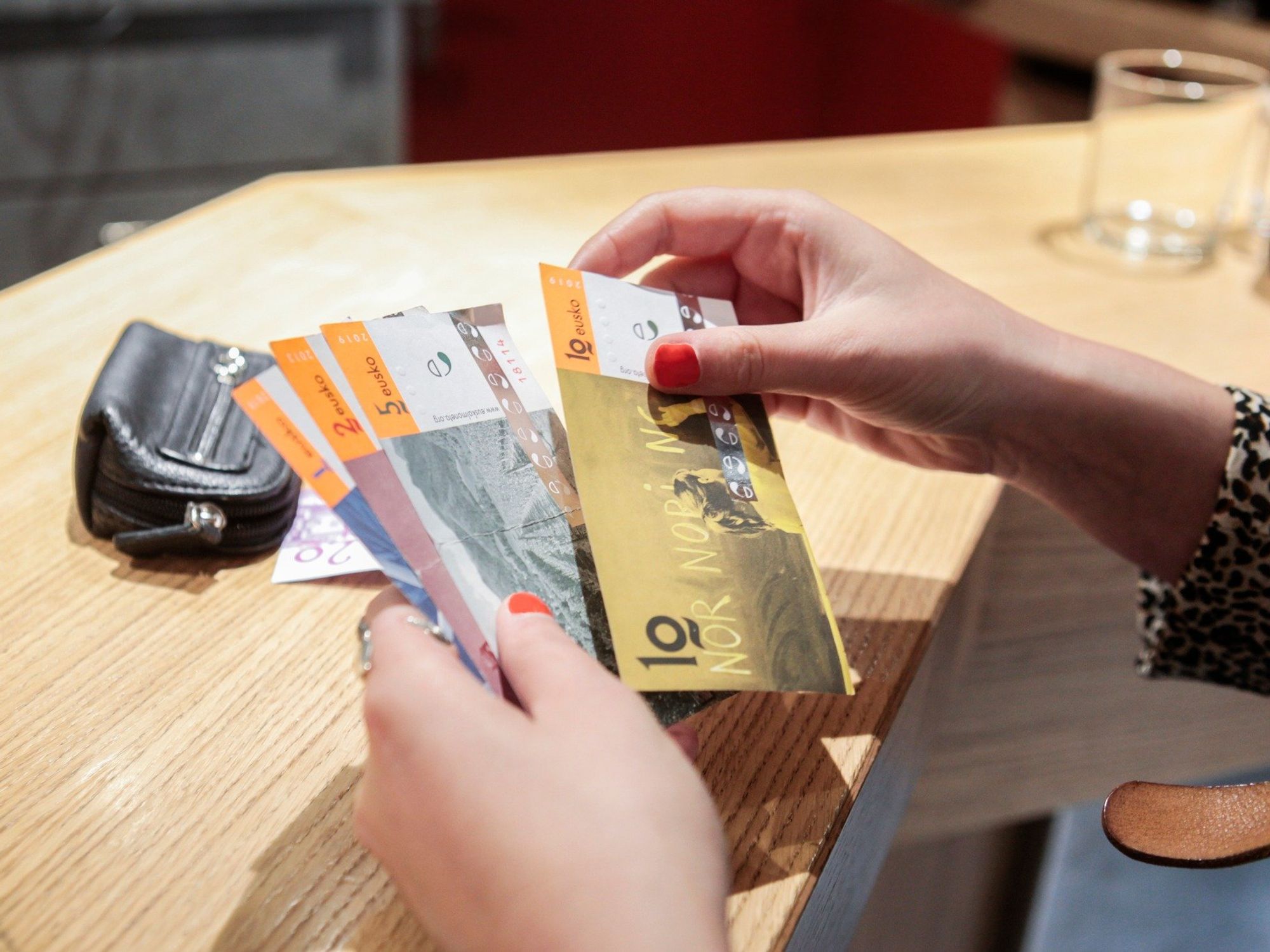 ​A woman counts Eusko currency, Sept. 20, 2023.