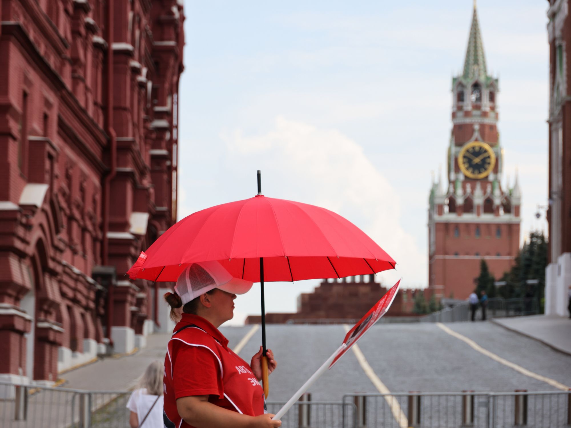 ​A woman holds a red umbrella in Moscow, Russia.