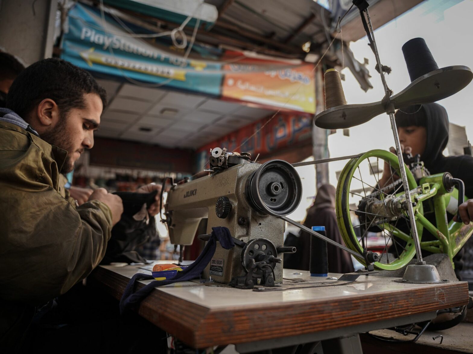 ​Amid power outage in Gaza, tailors use bicycle-powered sewing machine to repair things due to the lack of fuel and electricity.
