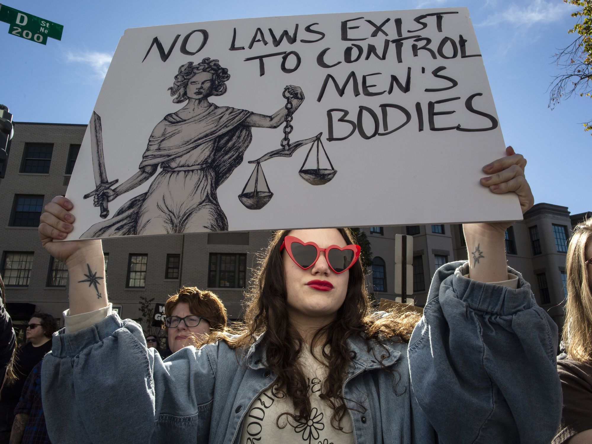 ​An abortion rights activist holding a protest sign at the Women's March in Washington DC in Nov. 2024.