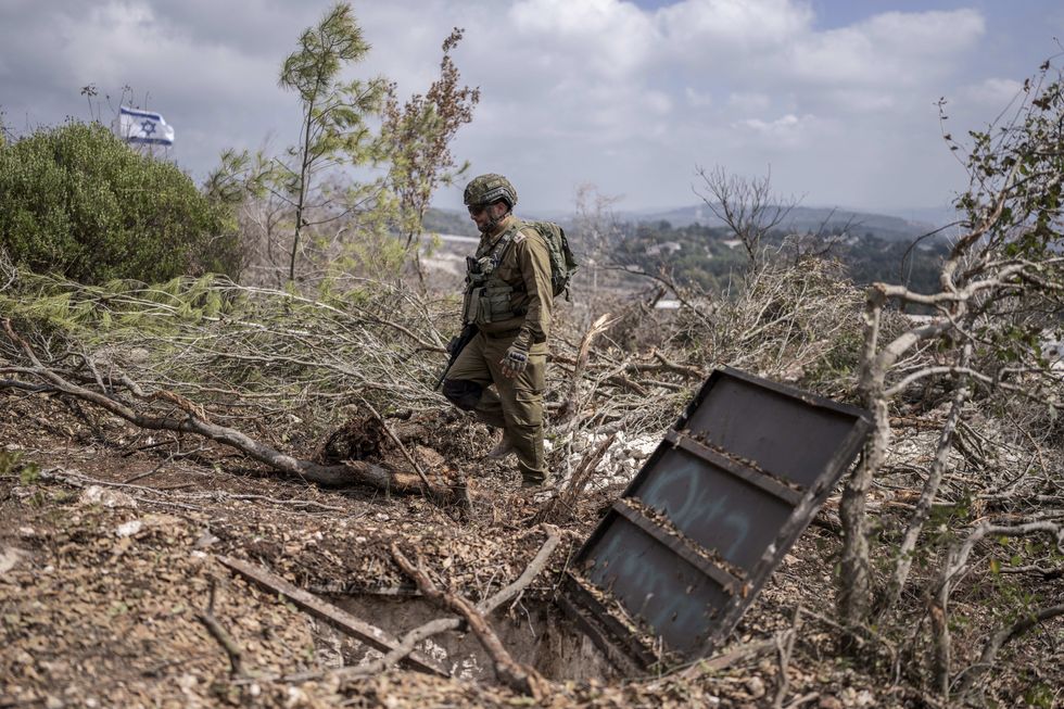 ​An Israeli soldier walking by a tunnel entrance in the southern Lebanese village of Naqoura along the border with Israel, Oct. 13, 2024.