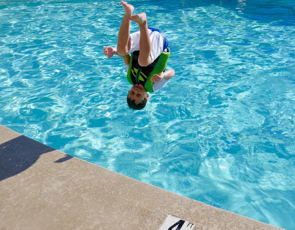 ​Child flipping into a swimming pool, Arizona, United States, Aug. 16, 2020.