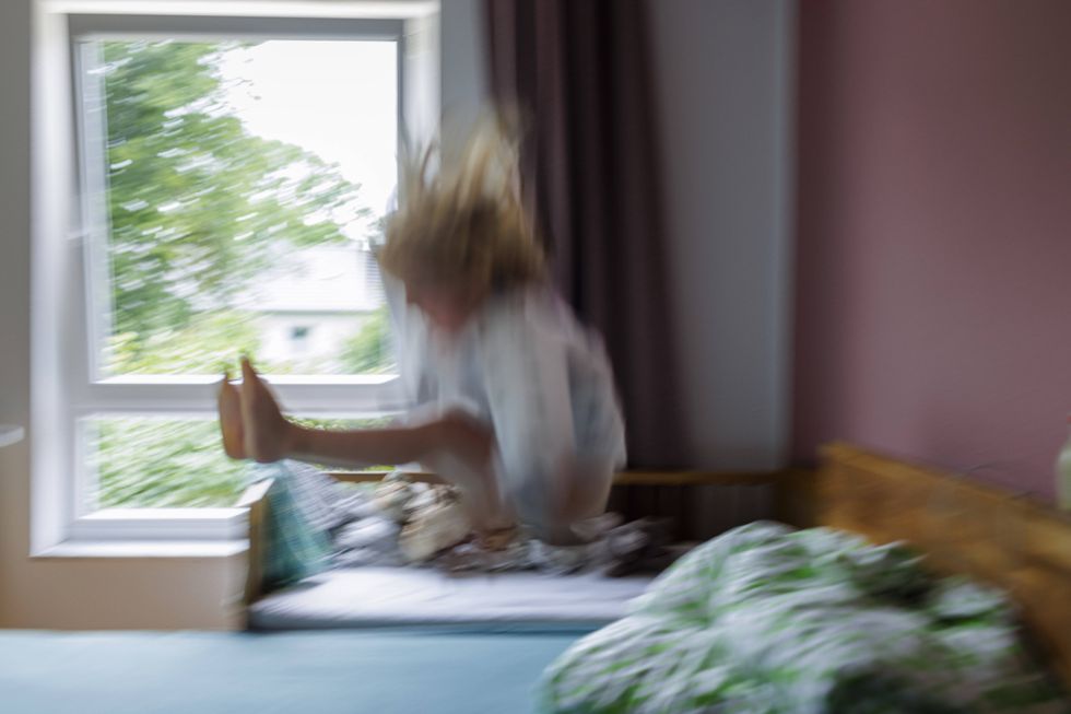 ​Child jumps on a bed, July 5, 2024.
