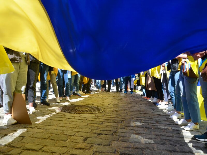 ​Demonstrator are seen holding a giant Ukrainian flag at Bowling Green Park in New York City