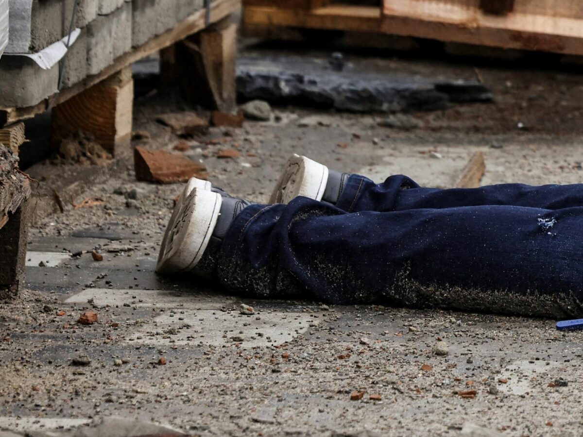 ​Detail of a photograph by AFP photographer Ronaldo Schemidt showing the legs of a body in the streets of Bucha, Ukraine