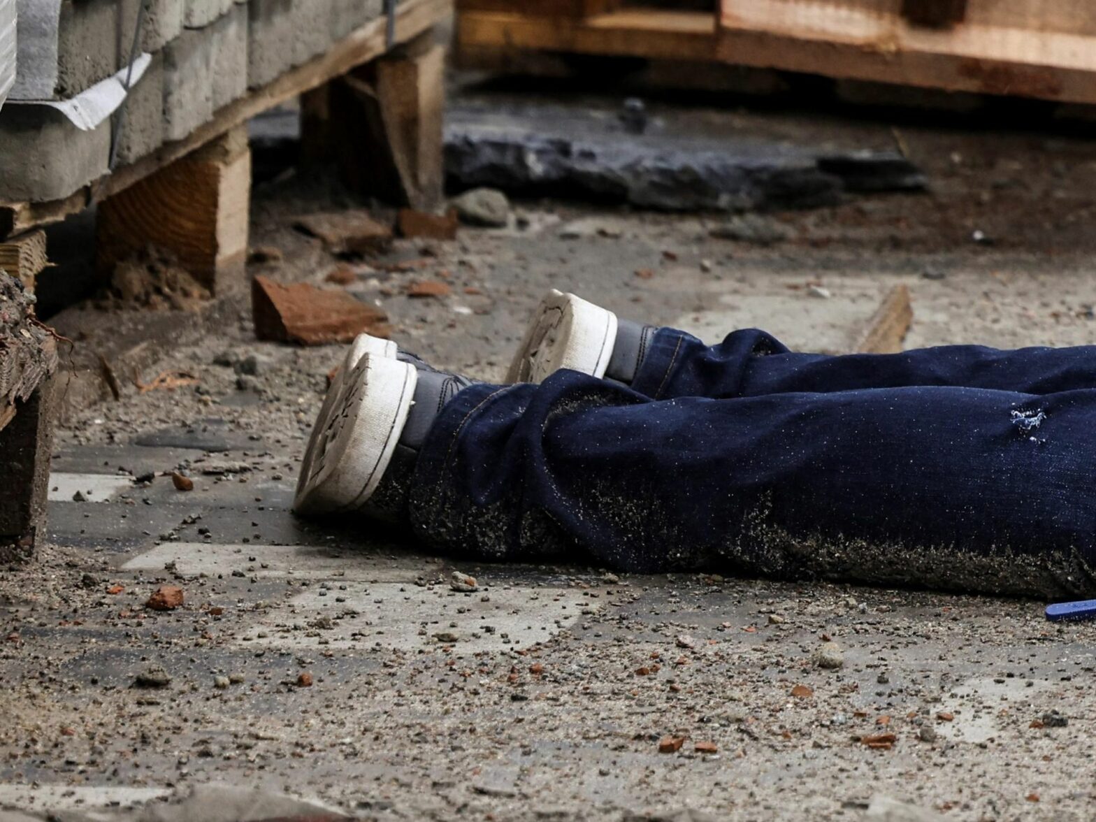 ​Detail of a photograph by AFP photographer Ronaldo Schemidt showing the legs of a body in the streets of Bucha, Ukraine