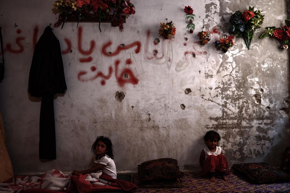 ​Displaced Syrian children live in a destroyed school as a result of a previous bombing in the city of Binnish.