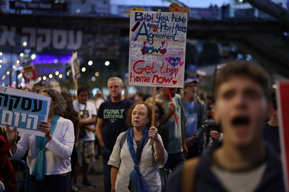 ​Families of hostages and their supporters take part in a protest at the ministry of defense calling the government to sign an ceasefire agreement with Hamas.