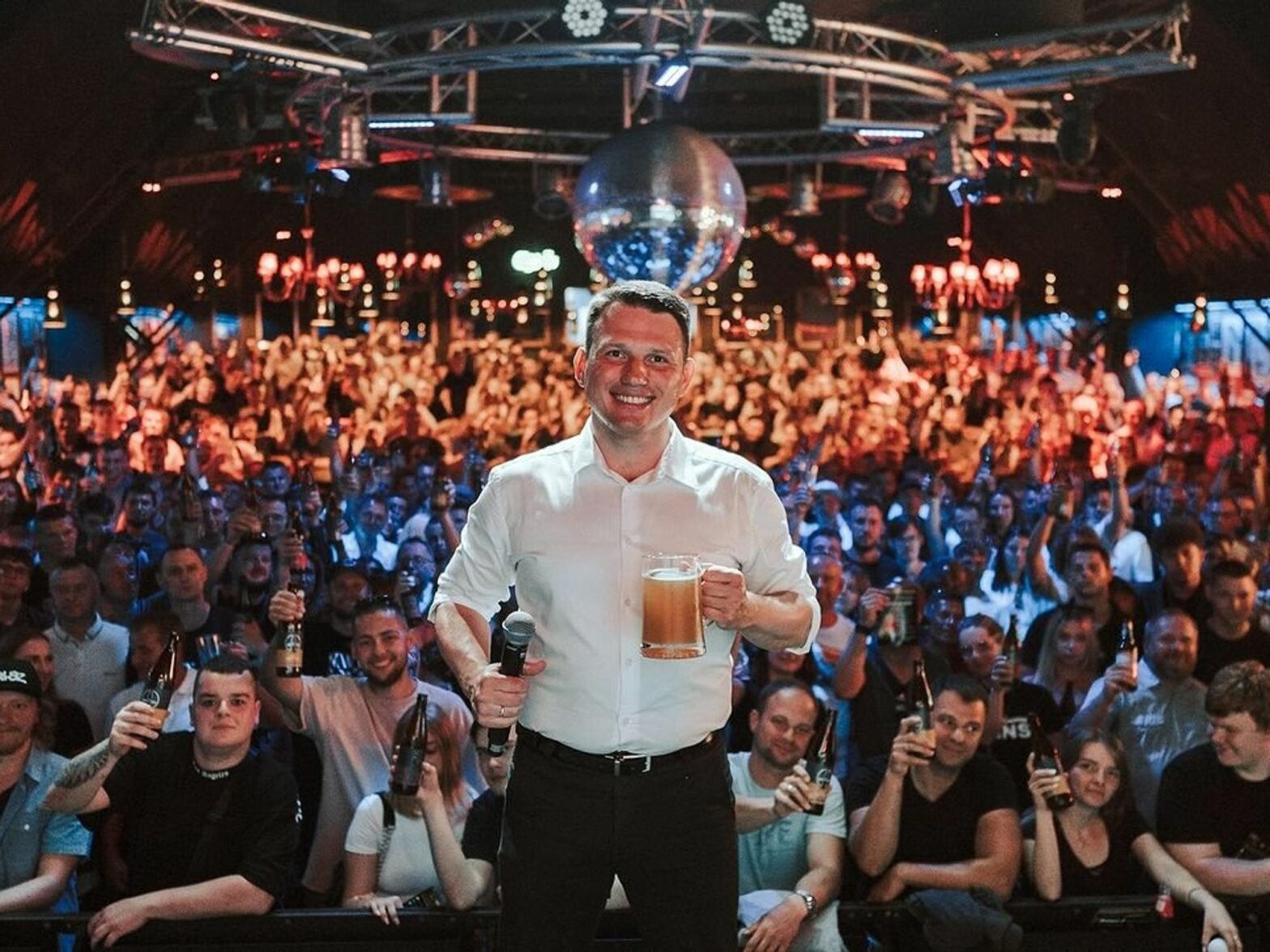 ​Far-right polish figure head Slawomir Mentzen posing with beer before a speech.​