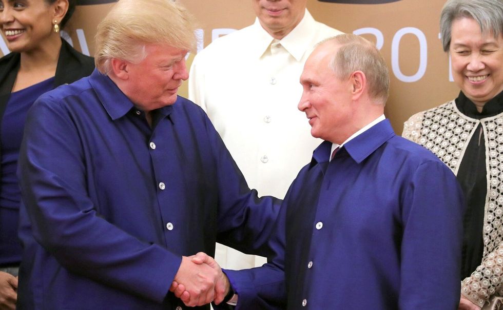 ​File photo of Donald Trump shaking hands with Vladimir Putin at the APEC Summit in Da Nang, Vietnam, in November 2017