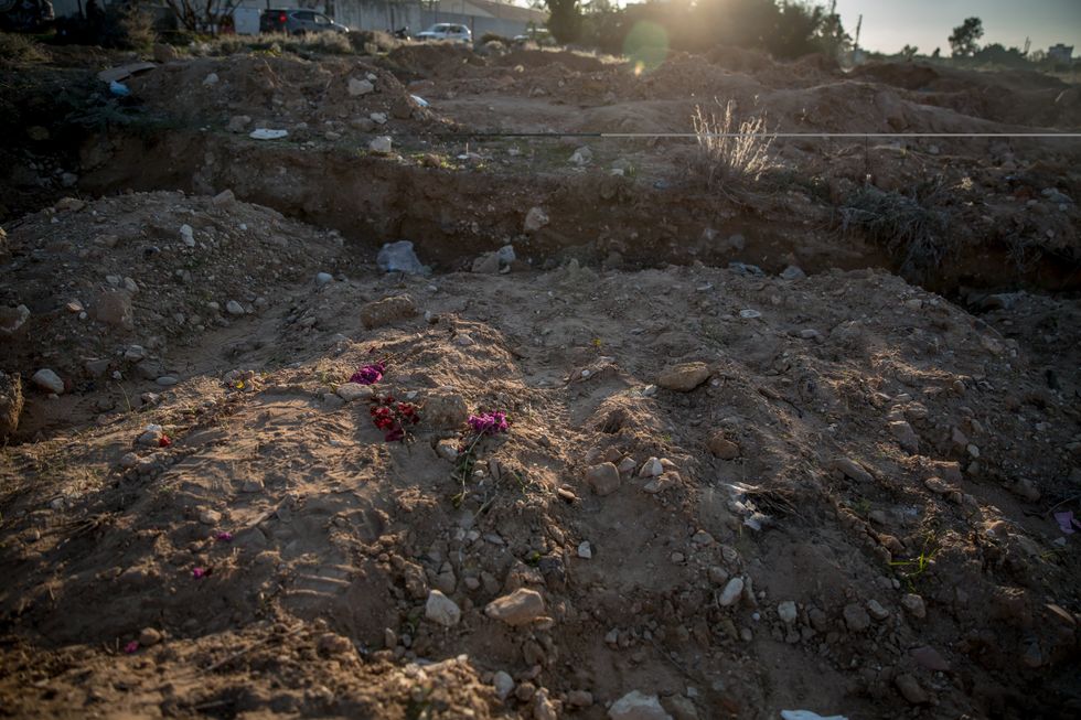​Flowers mark where people were buried in the city of Tyre, southern Lebanon, in a temporary graveyard where people were buried during the war, until their families could return to collect them, Dec. 3, 2024.