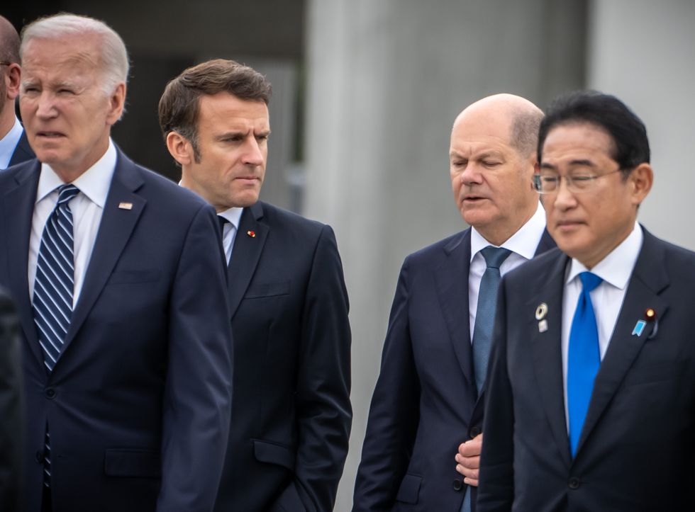 ​German Chancellor Olaf Scholz speaks with Emmanuel Macron at G7 summit.